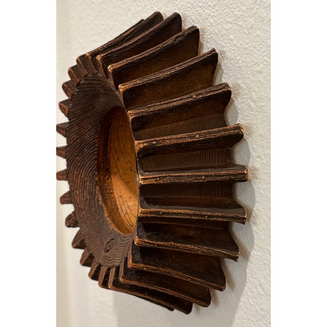 This petite scale mirror has the appearance of an antique wooden cog that was made into a mirror. It also could be...