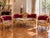 This refined circa 1970 French Louis XVI–style seating set consists of one sofa and two matching armchairs, combining...