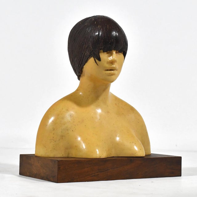 This evocative sculpture by Frank Gallo rendered in lacquered resin with a walnut base is of a sensitively rendered female...