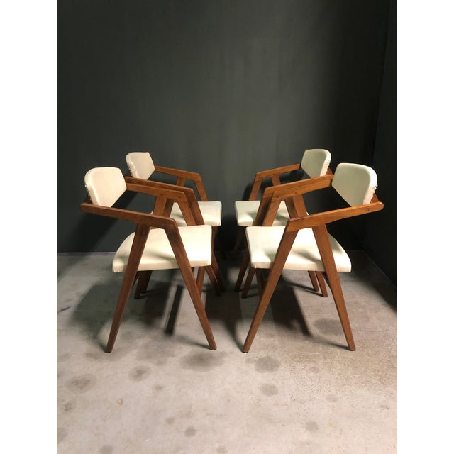 A rare set of 4 Italian dining chairs with original sprung seats and Skai upholstery.