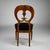 A fine Biedermeier period burl walnut chair from Austria circa 1820. The exuberant rounded back has a fanciful appeal and...