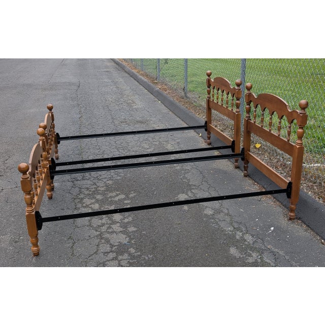 This exceptionally rare pair of vintage solid maple twin-size cannonball bed frames brings timeless American craftsmanship...