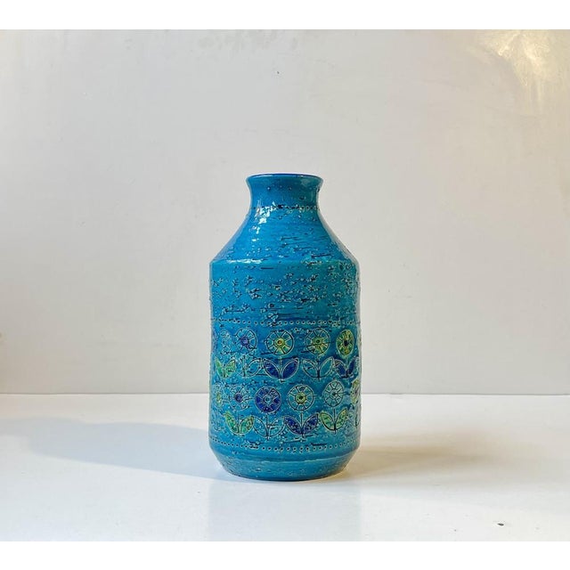 Eye-catching chamotte Stoneware vase decorated with turquoise glaze and colorful sunflowers. Designed by Aldo Londi and...