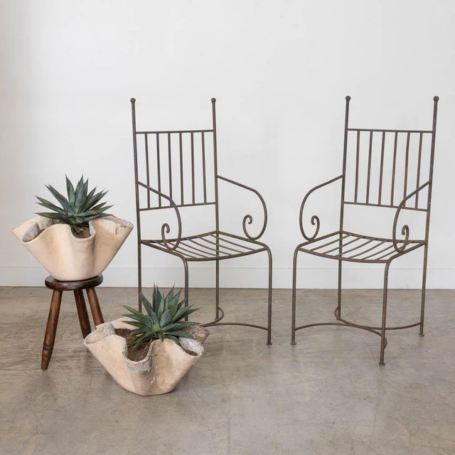 Lovely set of 4 iron outdoor chairs from France, 1940s. Beautiful scroll iron design on arms with slated iron back and...