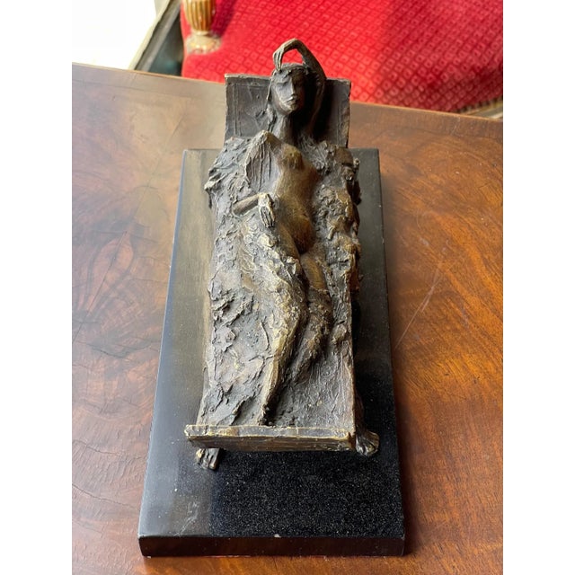 A small reclining woman sculpture. Made in the 1950s.