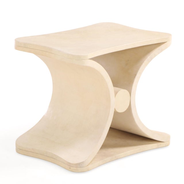 A sophisticated contemporary waterfall-form coffee or end table, clad entirely in parchment in the manner of Jean-Michel...