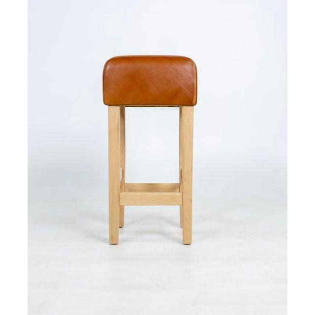 One Beautiful Bar Stool in the Style of Jean-Michel Frank, white oak base with cognac leather seat. The Leather is very...