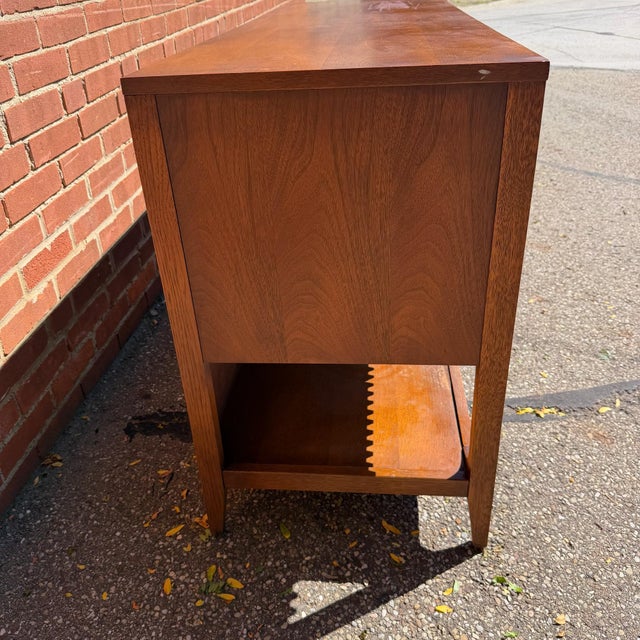 A harder-to-find Broyhill Brasilia credenza in walnut, with four fluted cabinet doors across the front. The collection’s...