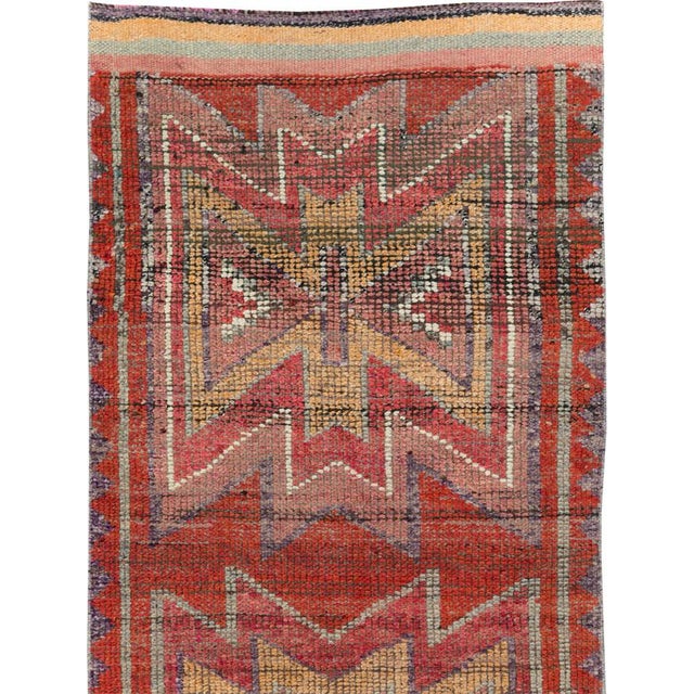 This mid-20th-century Turkish Anatolian tribal runner presents three large, vertically aligned geometric medallions across...