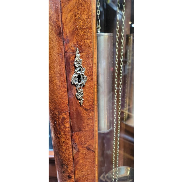 A nice French Style Louis XV Grandfather clock. Westminster Chime Burl Wood with Inlaid woods. Working condition keeps...