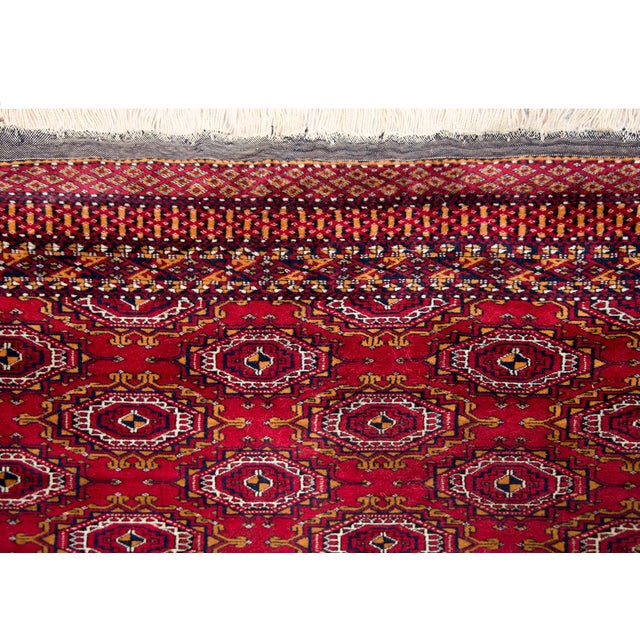 A wonderful late 20th century Persian Turkmen rug with an all-over stylized floral pattern surrounded by a complex border...
