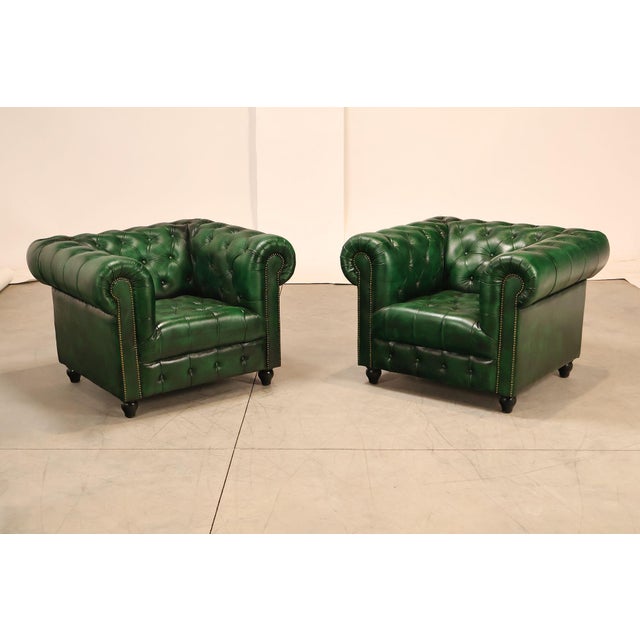 High Quality Pair of Tufted Green Leather Lounge Chairs with Brass Tack Trim, Mounted on Turned Feet