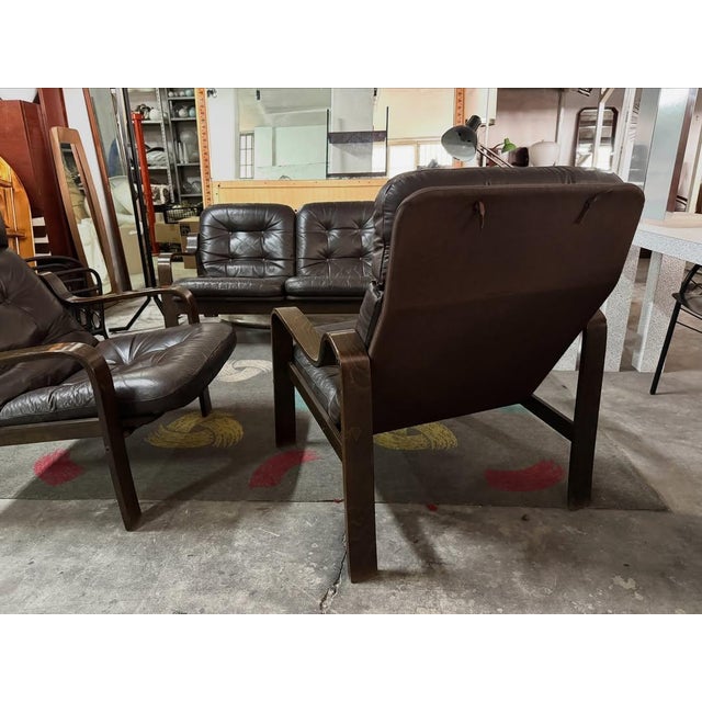Living room set by ingmar relling, consisting of a three-seater sofa and a pair of armchairs in dark brown genuine...