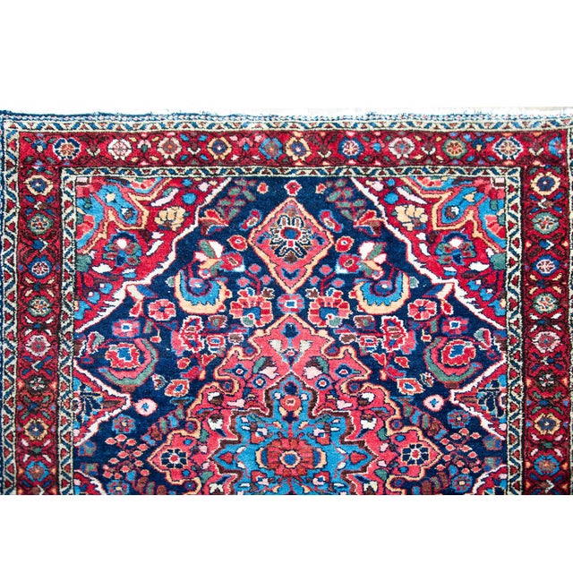 A beautiful early 20th century Persian Sarouk Mehraban rug with a complex central floral medallion living amidst a field...