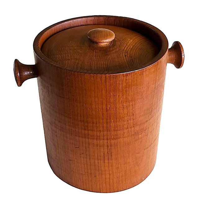 Offered is a 1960s heavy and large hand-carved Teak Wood Ice bucket in the style of Danish designer Fleming Digsmed. It...