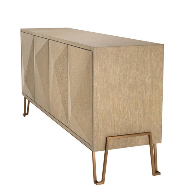 Dresser in washed oak veneer and brushed brass finish. Its metal structure and triangular door silhouettes are inspired by...