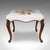 This is an antique fireside footstool. An English, needlepoint over walnut lounge stool, dating to the early Victorian...