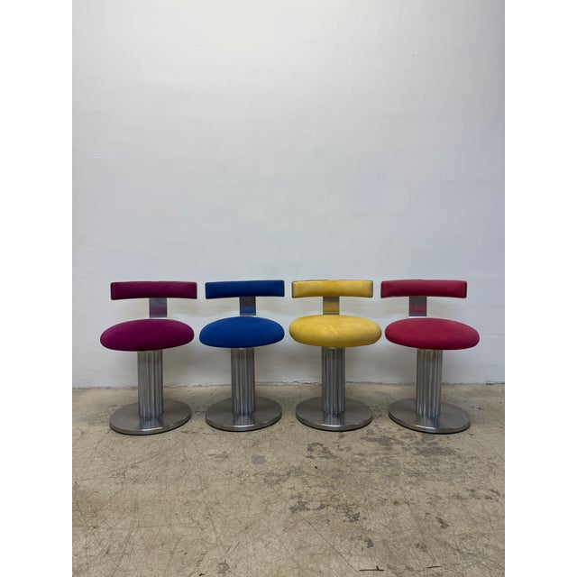 Set of four Designs for Leisure low counter stools with ultra suede fabric on steel frame bases. The swivel seat returns...