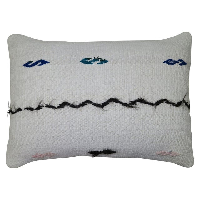 Pillow made from modern Turkish Kilim in white. Measures: 15" x 23".