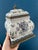 This exquisite lidded Capodimonte-style porcelain jar features finely detailed crest motifs, cherubs, birds, and floral...
