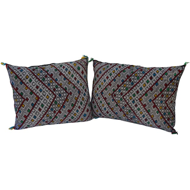 Pair of Moroccan pillows handwoven by the Berbers of the High Atlas Mountains. Featuring ornate display of diamond...