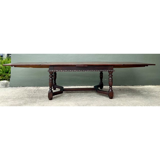 This vintage carved wood extension dining table combines robust construction with decorative late 19th- to early 20th-...