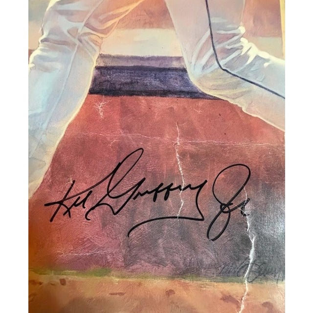 Offered is a 1990 limited edition Ken Griffey Jr. lithograph by William L. Maughan, hand-numbered 113/500 and signed by...