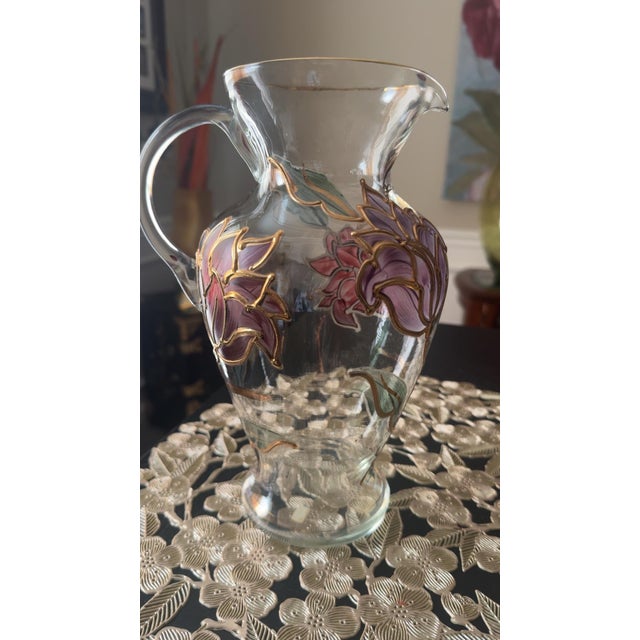 Add timeless elegance to your home with this stunning vintage hand-painted enamel glass pitcher, beautifully decorated...