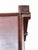 An elegant side table characterised by an architectural and geometric design crafted from fine wood. The supporting...