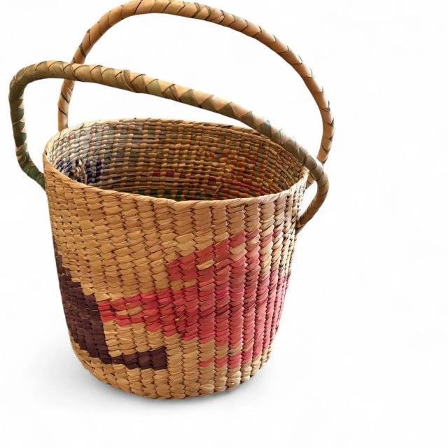 Beautifully handwoven from natural fibers, this vintage basket features a charming geometric pattern in warm earthy tones...