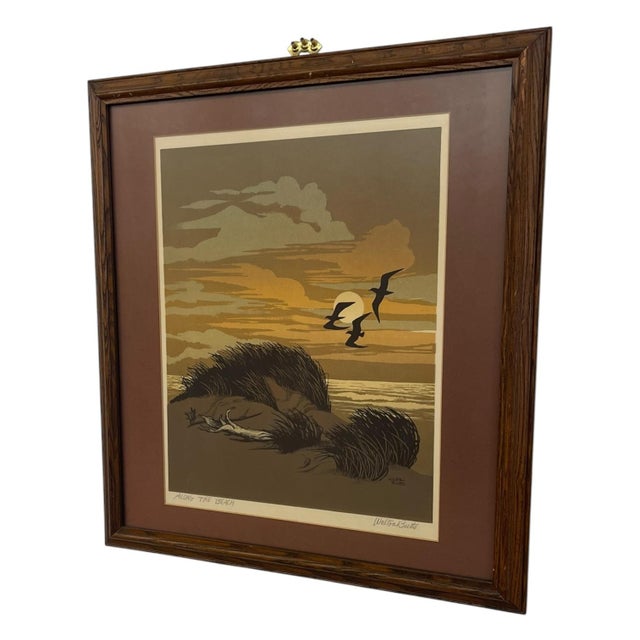 Signed art by Walton Butts titled "Along the Beach." The composition depicts a coastal landscape at sunset with windswept...