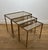 This beautiful set of neoclassical-style nesting tables is made of brass with smoked glass tops. It is a French work by...