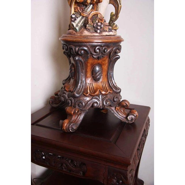 Hand-carved wooden lamp with rich polychromy. Atypical design, where a boy carries the light in the Baroque style....