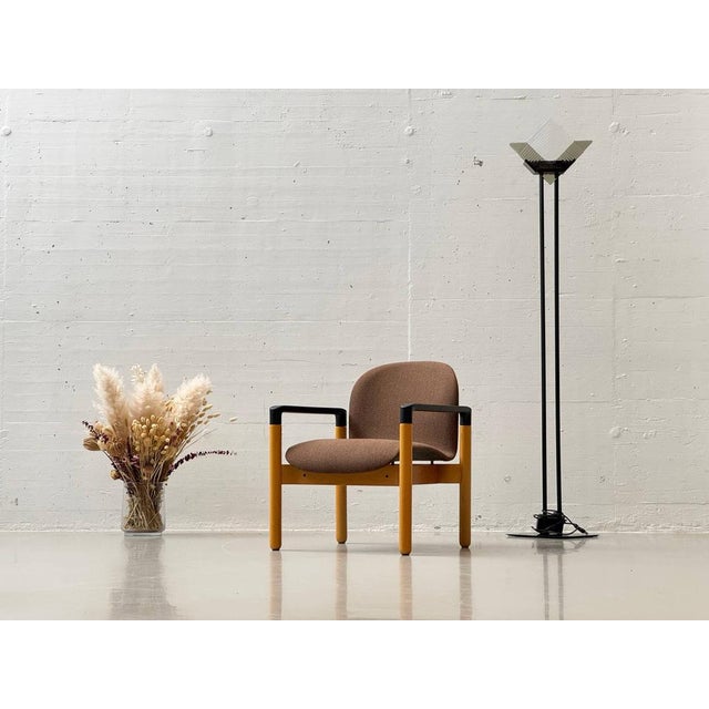 A functional vintage armchair from gerd lange's flex series for thonet. The design combines a sturdy beechwood frame with...