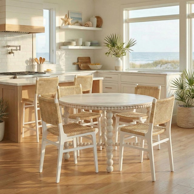 The dining chair, expertly crafted with Teak, painted in True White, and with a woven natural rattan seat and back....