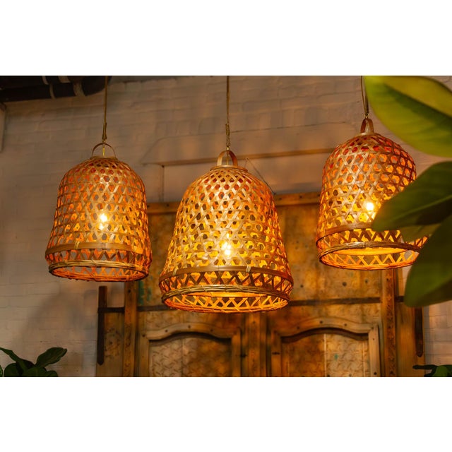 A monumental focal point of organic light and shadow. The Grand version of our Indonesian Bamboo Pendant serves as a...