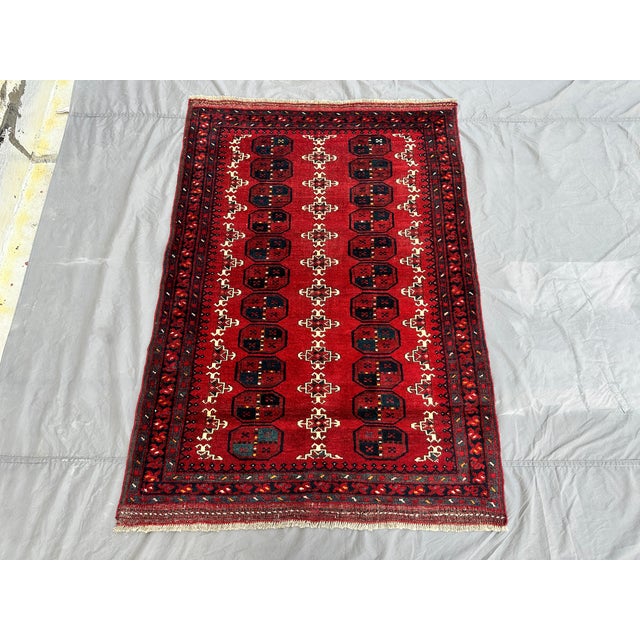 This hand-knotted Khal Mohammadi rug features two tidy columns of quartered octagonal guls in navy and ivory, separated by...
