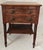 An early 19th century American Federal period two-drawer stand crafted in figured maple, displaying strong tiger grain...