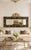 A very substantial size late 20th-century mirror featuring a hand-painted black panel with scrolling floral motifs, framed...
