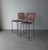 Pair of perfectly patinaed, woven leather, bar stools. Stools have beautifully worn leather woven on solid black iron...