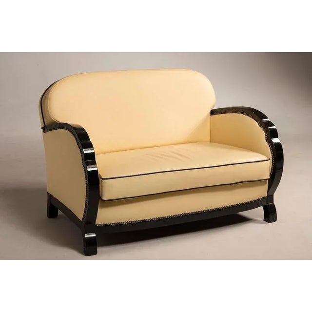 The entire ensemble features elegant black leather details contrasted by ivory-colored leather upholstery. One of the...
