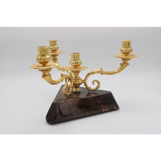An Aldo Tura Modernist three-arm candelabrum. Patinated brass arms with wooden base covered in lacquered parchment.