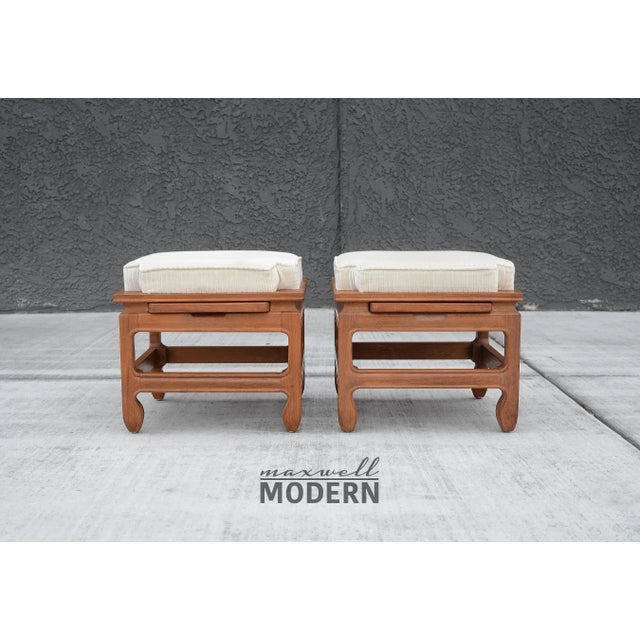A super rare pair of mid century modern low stacking stools with upholstered seats and pull out trays containing anodized...