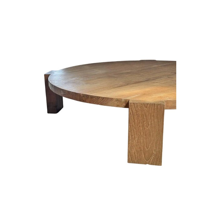 Crafted from solid teak wood, this striking round table is defined by its bold proportions and sculptural architectural...