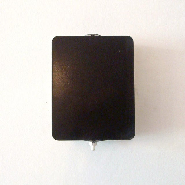 Iconic black and white enameled wall lights by Charlotte Perriand, adjustable reflectors, can be mounted horizontally or...