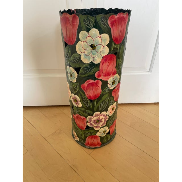 This vintage black metal umbrella stand features intricate hand-painted flowers and leaves, adding a touch of elegance to...