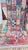 One-of-a-kind handwoven Moroccan rug. A patchwork Boujaad in dusty rose and clay — angular teepee-line figures and...