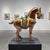 A sculptural ceramic horse rendered in the historic Tang dynasty Sancai tradition, featuring flowing amber, olive, and...
