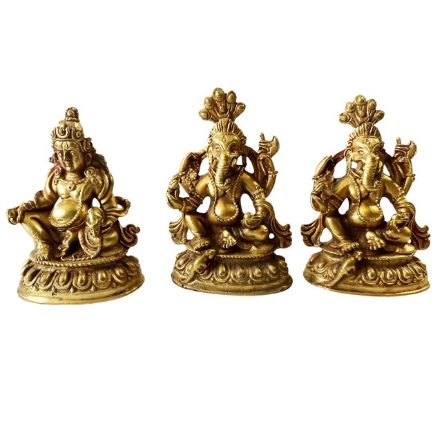 This set features three vintage Nepalese deity figures, including two Ganesh and one Jambhala, each measuring...