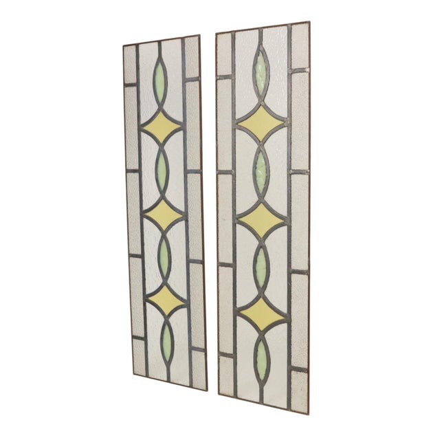 A lovely set of two vintage, narrow stained-glass panels featuring a colorful geometric pattern—perfect as suncatchers....